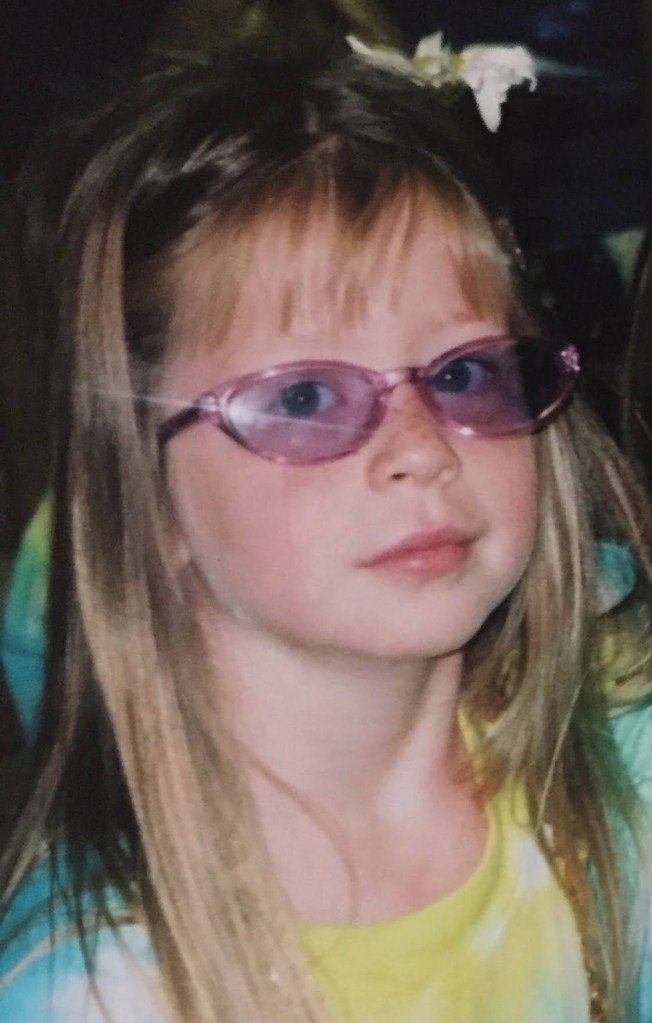 Picture of Mary Frances in Kindergarten wearing a tie-dyed shirt and purple sunglasses